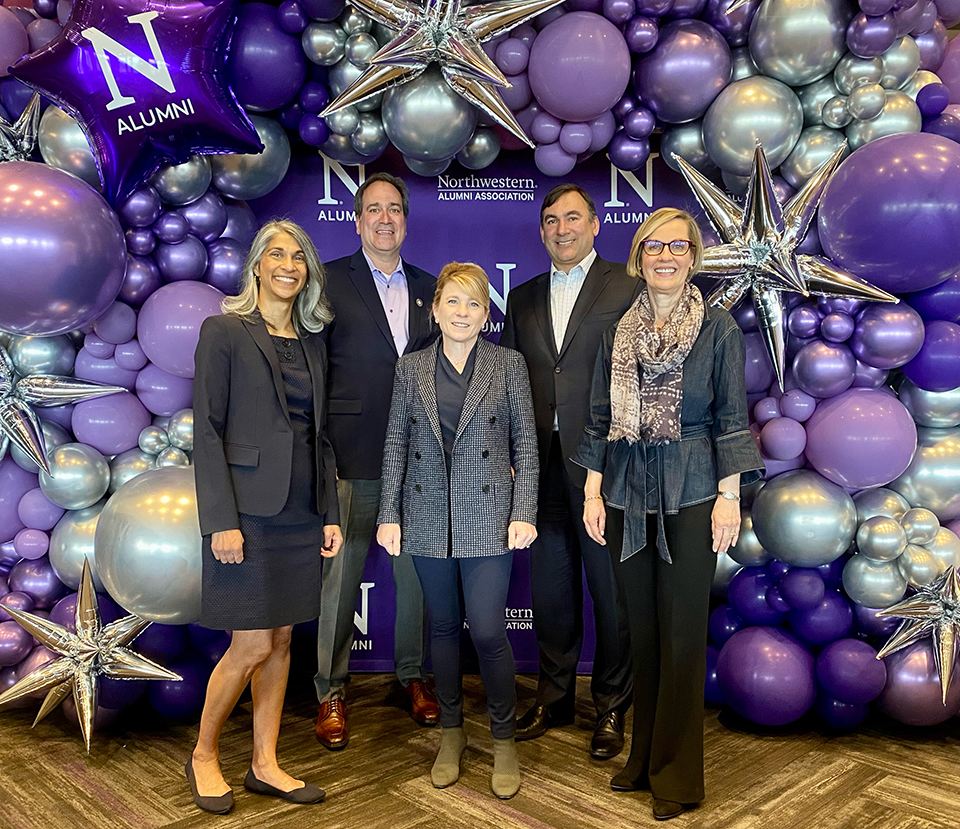 Portrait of faculty leaders in front of purple, white and silver balloons at the annual Day With Northwestern event on the Evanston campus