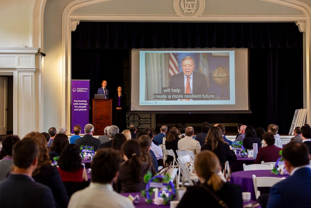 CSB co-directors Julius Lucks and Danielle Tullman-Ercek watch as US Senator Richard Durbin's recorded remarks play.